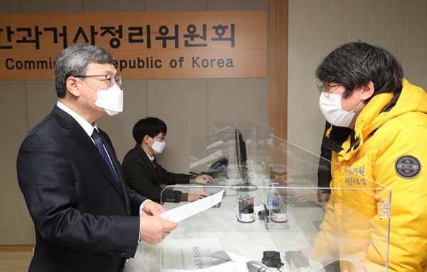 10日、ソウル市内の「真実和解委員会」事務局で鄭根植委員長が、『兄弟福祉院』事件の真実究明を求める申請書を受け取っている。聯合ニュース提供。